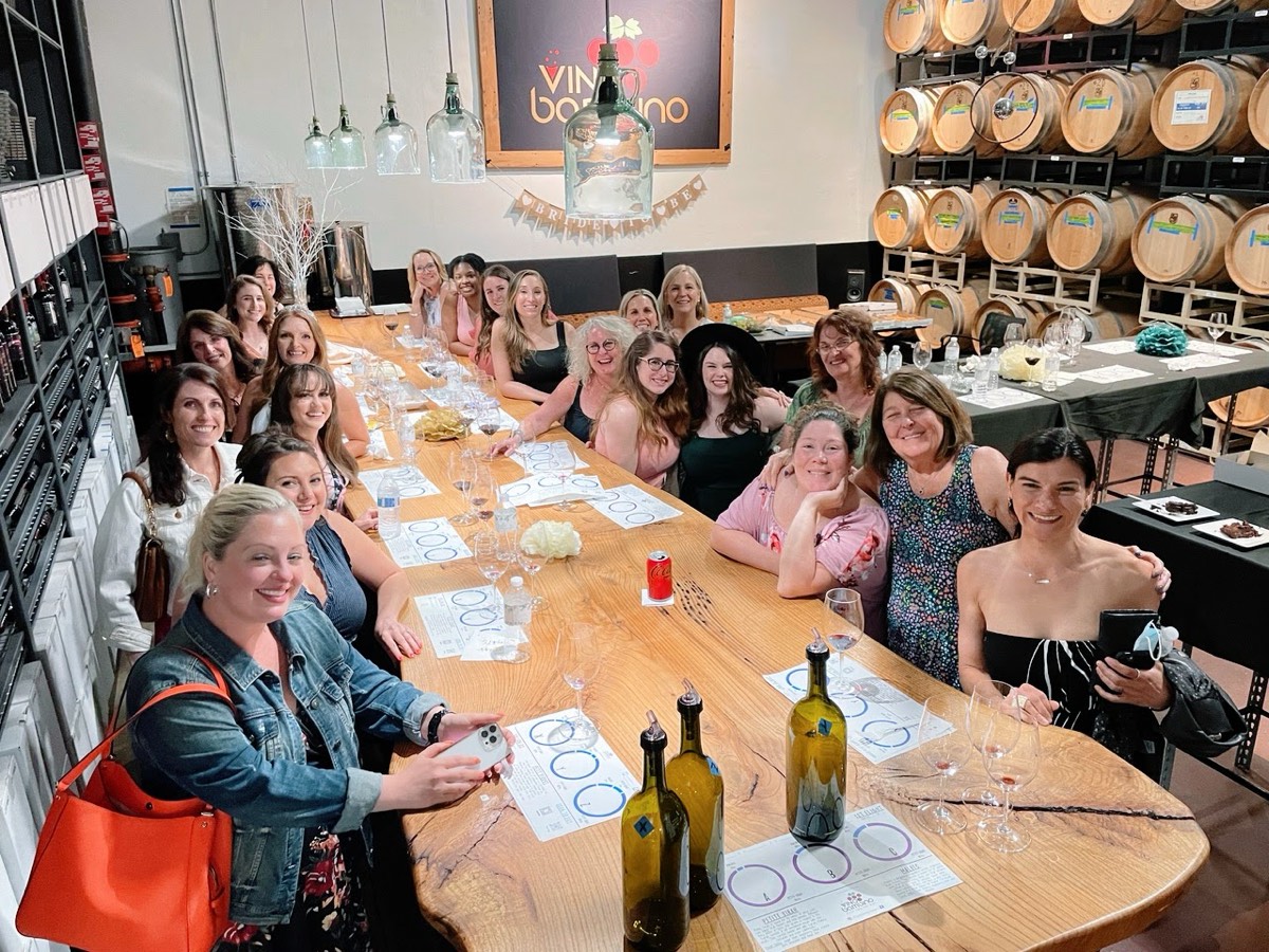 A bridal party enjoying a wine blending event at Vino Bambino Winery