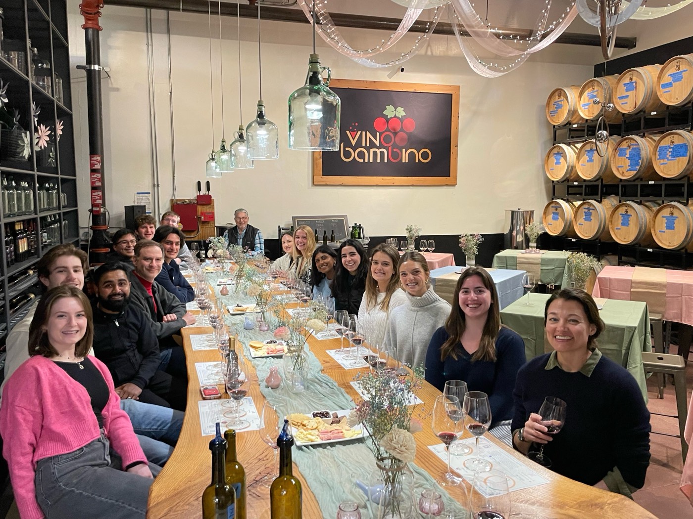 A large group seated around the Vino Bambino wine blending table